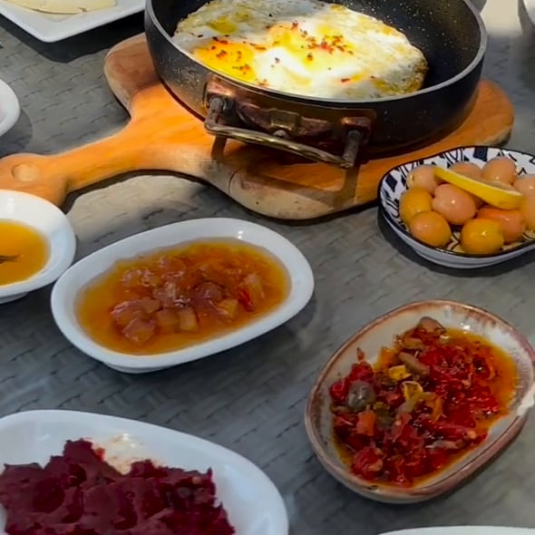 Serpme kahvaltı: sahanda yumurta, zeytin, reçel, biber ve pancar.
